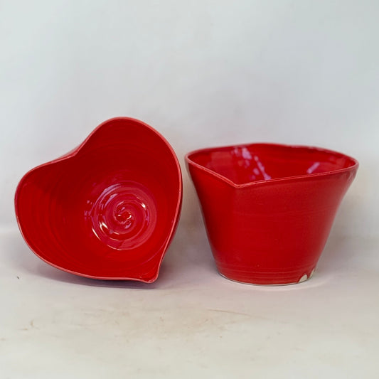 Two red ceramic bowls on a white background