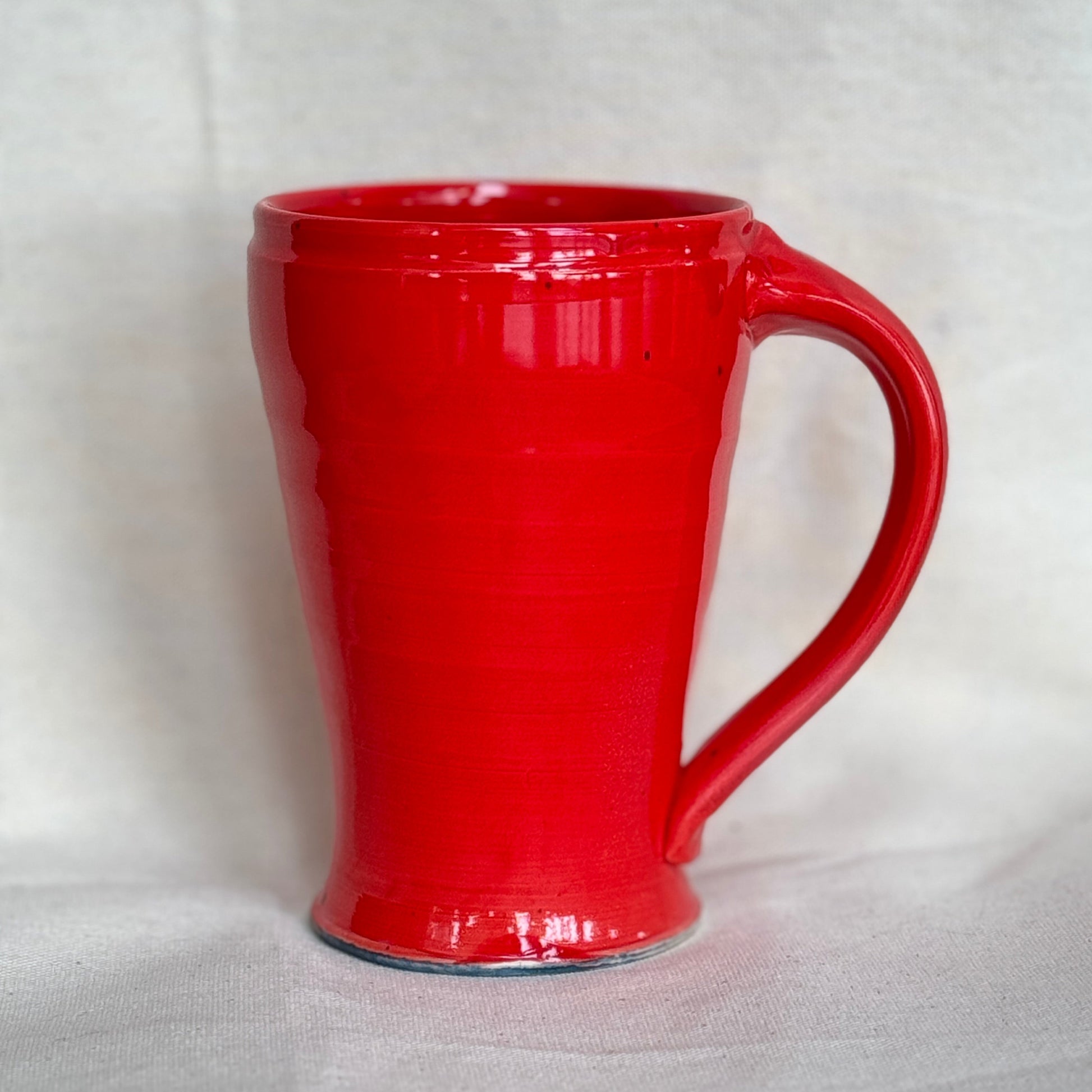 Red ceramic mug on a white background