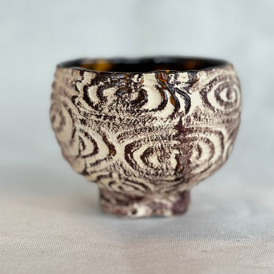 Decorative ceramic bowl with intricate patterns on a light background