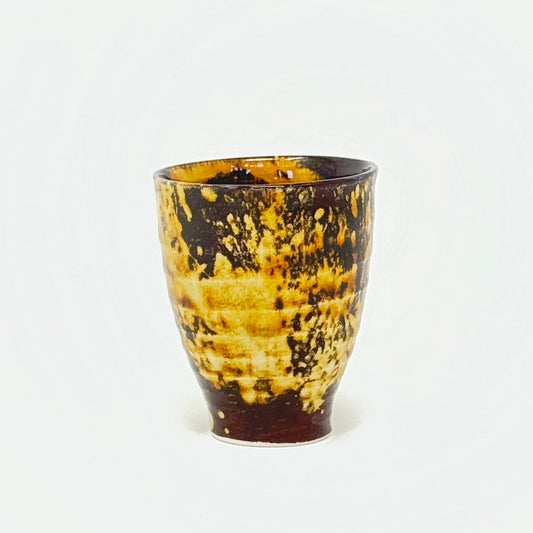 Brown and gold tea cup