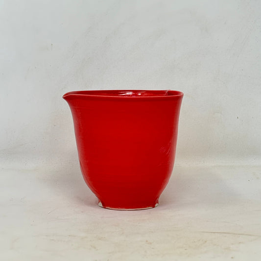 Red ceramic cup on a white background