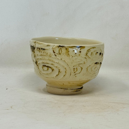 Ceramic bowl with decorative patterns on a white background