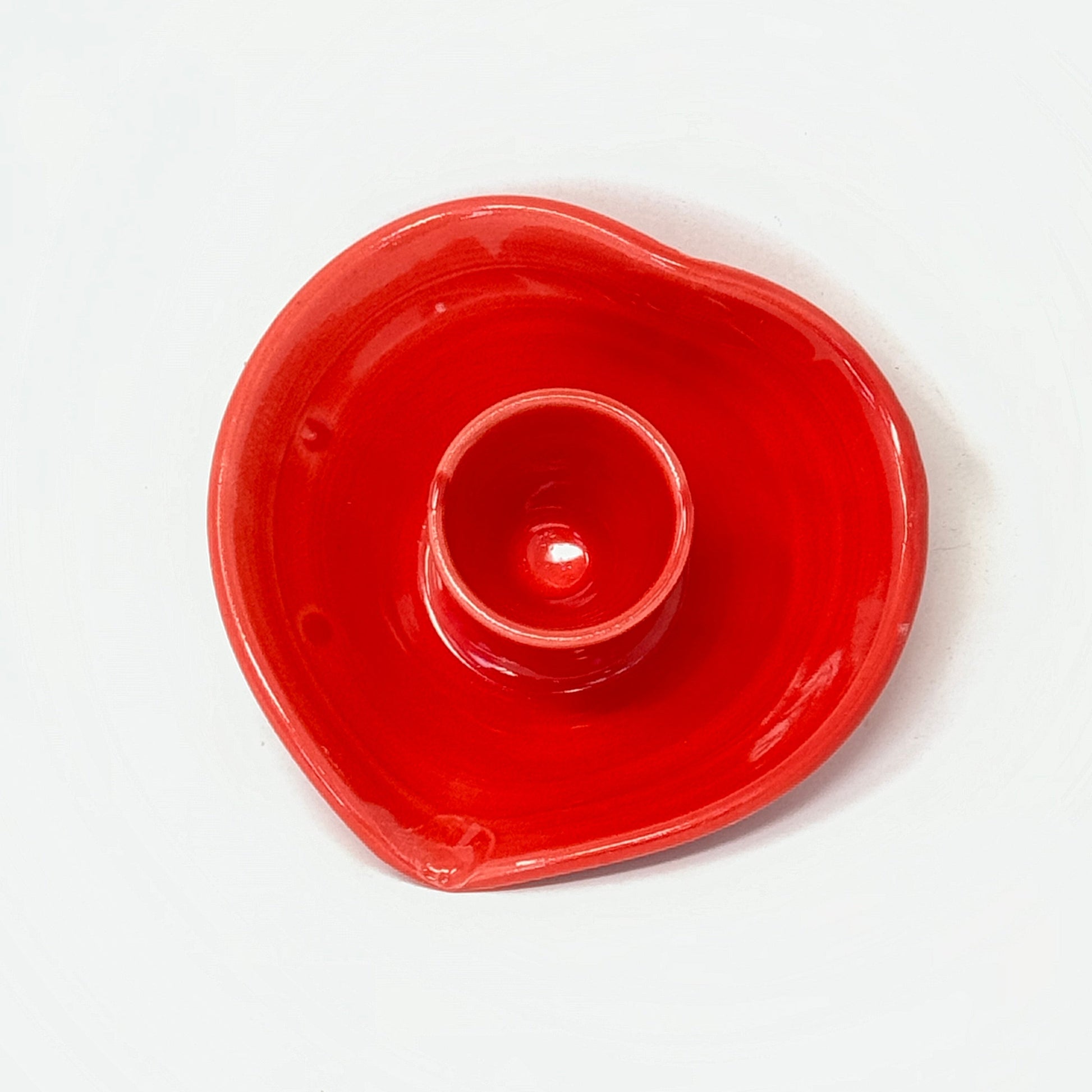 Red ceramic candle holder on a white background