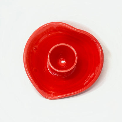 Red ceramic candle holder on a white background