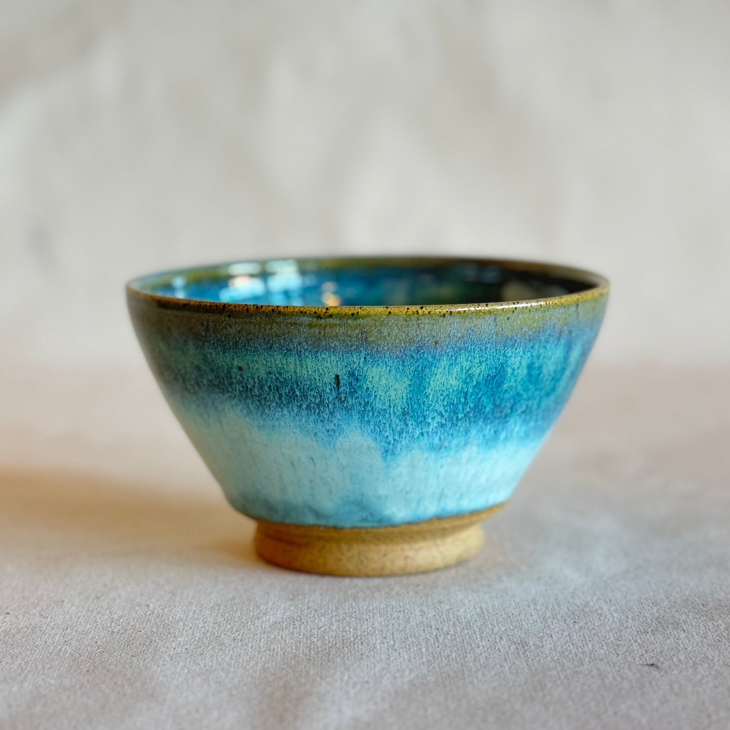 Blue ceramic bowl on a neutral background