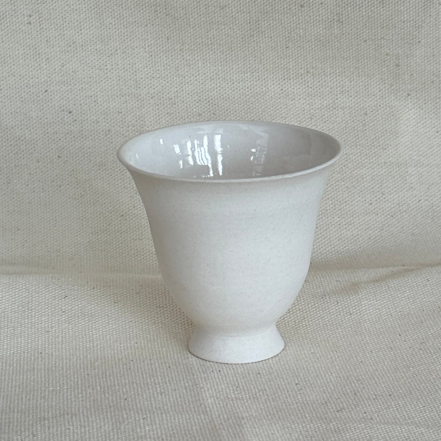 White ceramic cup on a textured gray background