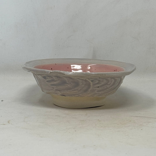 Decorative ceramic bowl with intricate design on a white background