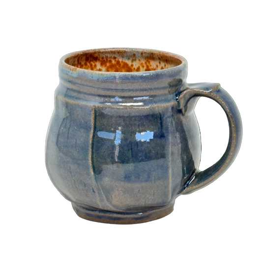 Blue ceramic mug with a handle on a white background