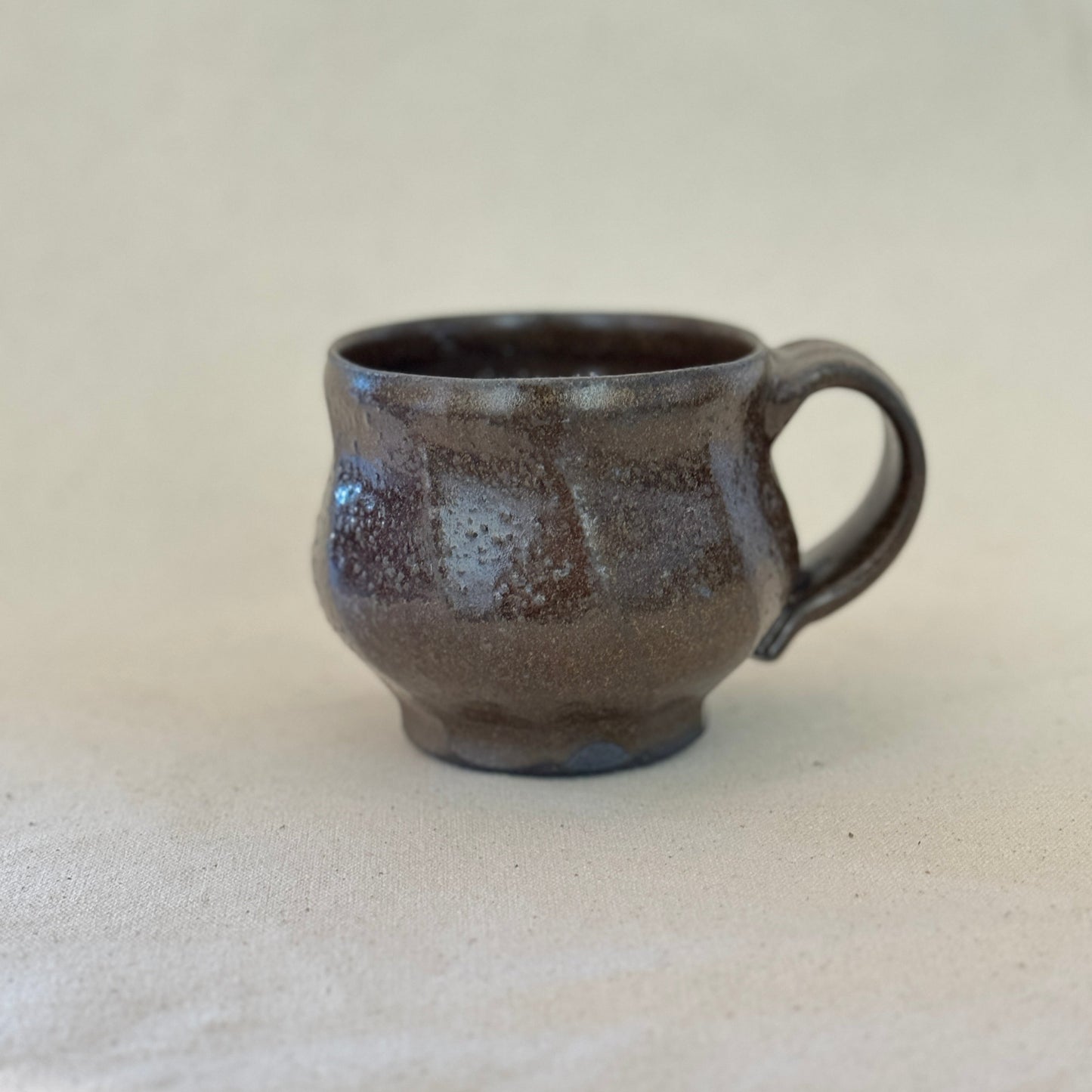 Brown ceramic mug on a light gray background