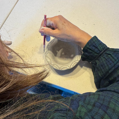 Person trimming pottery